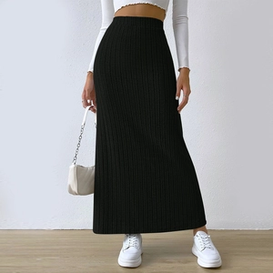 Detailed texture of black high waisted ribbed knit maxi skirt with elegant side slit