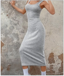 Detailed texture of grey ribbed knit fabric on a slim fit maxi dress with a side slit