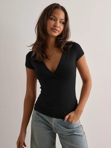 Close-up of slim fit black deep V-neck short sleeve top with crossover wrap design