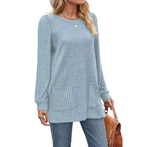 Detail of light blue ribbed knit tunic featuring round neck and dual front pockets