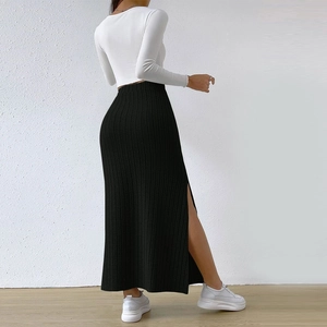 Detailed view of black high waist knit maxi skirt with side slit and ribbed texture