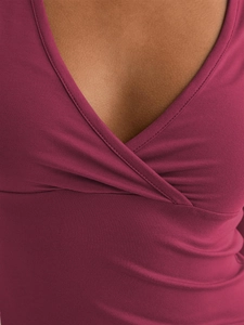 Detail of V-neck wrap top showing fine stitching and soft burgundy knit fabric texture