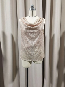 Detail of rose gold sequin tank top with draped neckline and reflective surface