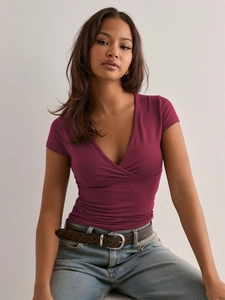 Close-up of slim fit deep V-neck dark red T-shirt with wrap style fabric texture