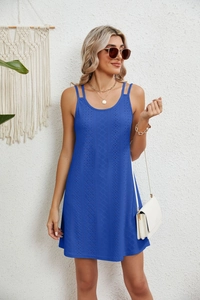 Detail of royal blue sleeveless dress with intricate hollow wavy textures and double straps