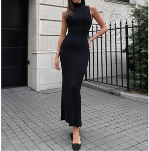 Detailed close-up of a black sleeveless turtleneck maxi dress with vertical ribbing texture