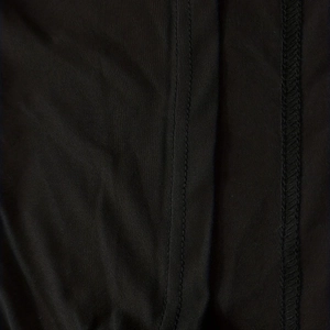 Macro detail of high-elastic black fabric showing professional double-needle stitching