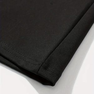 Macro shot of high-quality double-needle stitching on black elastic dress fabric