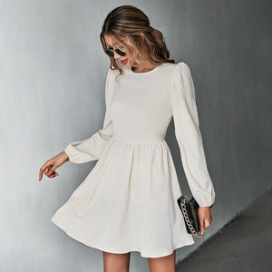 Detail view of a creamy white A-line dress with puff sleeves and cinched waist for women