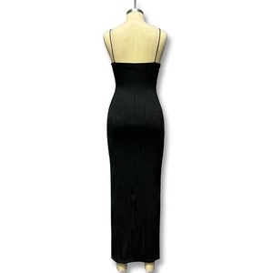 Detail of black pleated maxi dress showing spaghetti straps and low back design on mannequin