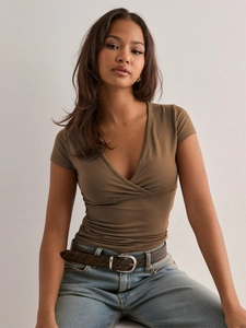 Detail of slim-fit brown deep V-neck wrap shirt showing soft cotton blend fabric texture