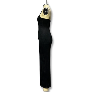 Detail of black slim-fit maxi dress featuring vertical pleated texture and thin straps