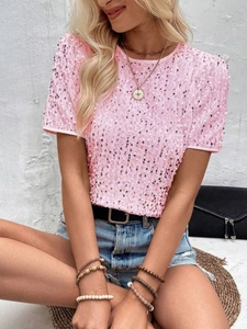 Close-up detail of shimmering pink sequins on a stylish short sleeve crewneck T-shirt
