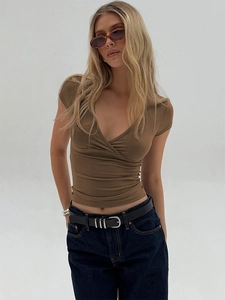 Close-up of women's slim fit V-neck wrap T-shirt in coffee brown knitted fabric