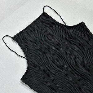 Detailed macro view of black spaghetti strap dress featuring premium wavy pleated texture