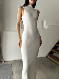 Close-up of elegant white ribbed knit fabric on a high-neck sleeveless bodycon dress