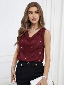 Detail of burgundy sequin V-neck top paired with black high-waisted belted trousers