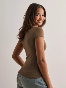 Detail of slim fit brown short sleeve T-shirt showing fabric texture and V-neckline cut