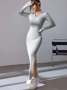 Close-up of elegant light grey ribbed knit dress featuring a deep V-neck and collar detail