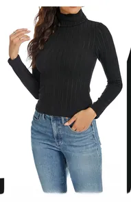 Detail of black turtleneck ribbed knit long sleeve top paired with classic blue denim jeans