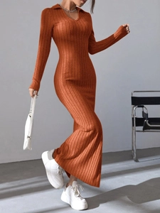 Close-up detail of rust red ribbed knit dress with V-neck lapel and elegant slim fit