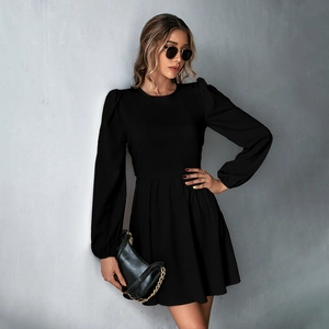 Detail shot of black A-line dress featuring stylish puff sleeves and fitted waistline