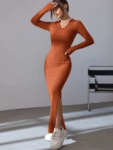 Detailed knit texture and high side slit of a burnt orange long-sleeve midi dress