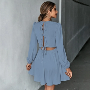 Detail of the open-back design on blue mini dress with three decorative ribbon bows