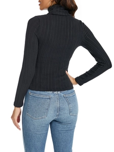 Detail view showing the ribbed knit texture and slim fit design of the black turtleneck top