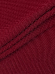 Close-up of wine red knitted fabric texture with professional double flat seam stitching