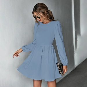 Detail of grey-blue mini dress featuring puff sleeves and high-waisted pleated design
