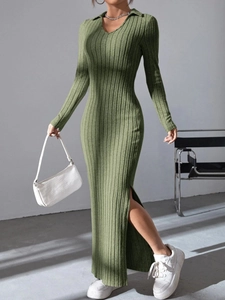 Detail of elegant knit dress featuring a polo collar and a high side slit in grass green