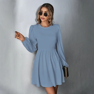 Detail view of high-waist light blue mini dress featuring puff sleeves and pleated A-line skirt