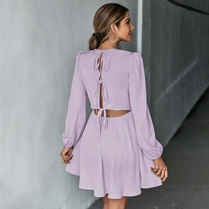 Detail of lavender mini dress featuring three back tie bows and elegant open back design