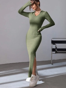 Detail of elegant ribbed knit dress showing the soft polo collar and slit hemline