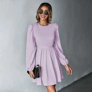 Detailed view of lavender bubble sleeve dress with cinched waist and pleated skirt