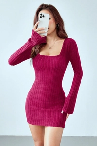 Close-up of hot pink ribbed knit fabric and off-shoulder long sleeve cuff detail