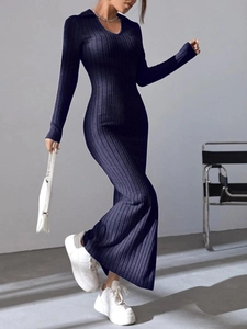 Detailed texture of dark blue ribbed knit maxi dress with elegant V-neckline