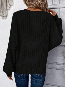 Detail of black rib-knit sweater back view with drop shoulder design in a stylish room