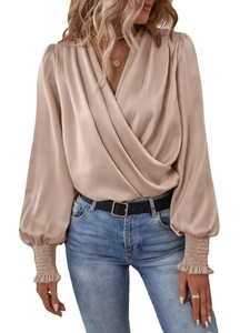 Elegant champagne satin V-neck blouse featuring smocked lantern sleeves and ruffled cuffs
