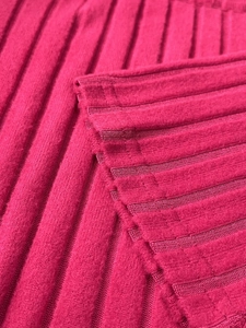 Close-up detail of magenta ribbed knit fabric texture on a slim-fit bodycon dress