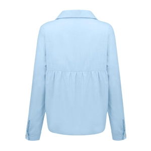 Detail view of the back pleat and textured fabric on light blue linen shirt for women