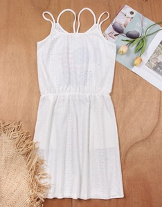 Detail of white hollow-out embroidery beach cover-up with cross back and thin straps