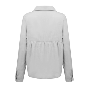 Detail view of the back of a light grey linen shirt featuring elegant pleated design