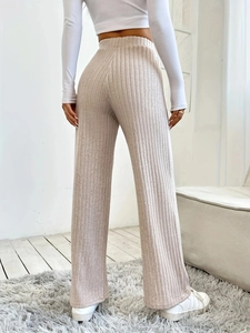 Beige high-waisted ribbed knit wide-leg pants for women shown in a back view