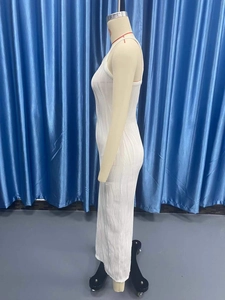 Close-up of the vertical ribbed knit texture on a white sleeveless bodycon maxi dress