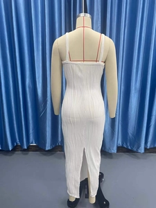 Close-up of white sleeveless bodycon dress featuring vertical wavy textured pleat fabric