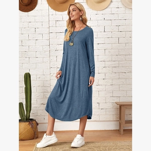 Detail of loose fit long sleeve knit dress in navy blue with side pockets and curved hem