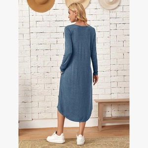 Detailed side view of navy blue long sleeve dress with curved hem and side pockets