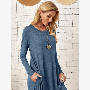 Detail of loose-fit knit dress featuring side pockets and a curved hemline design